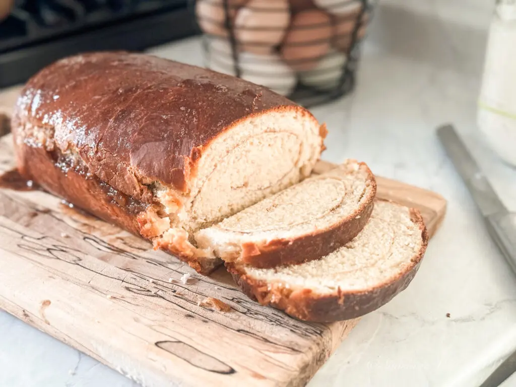 Sourdough Cinnamon Swirl Bread (Tastes Like a Cinnamon Roll!) 1 sourdough cinnamon swirl bread on a wooden cutting board