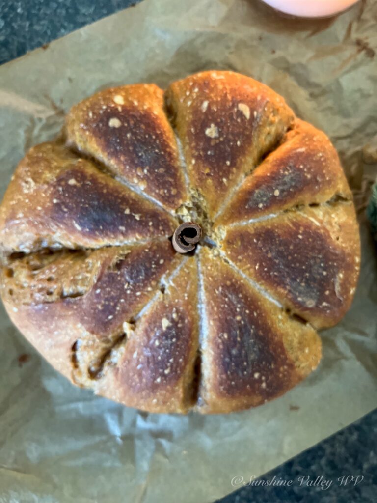close up of homemade pumpkin sourdough bread with visible scoring