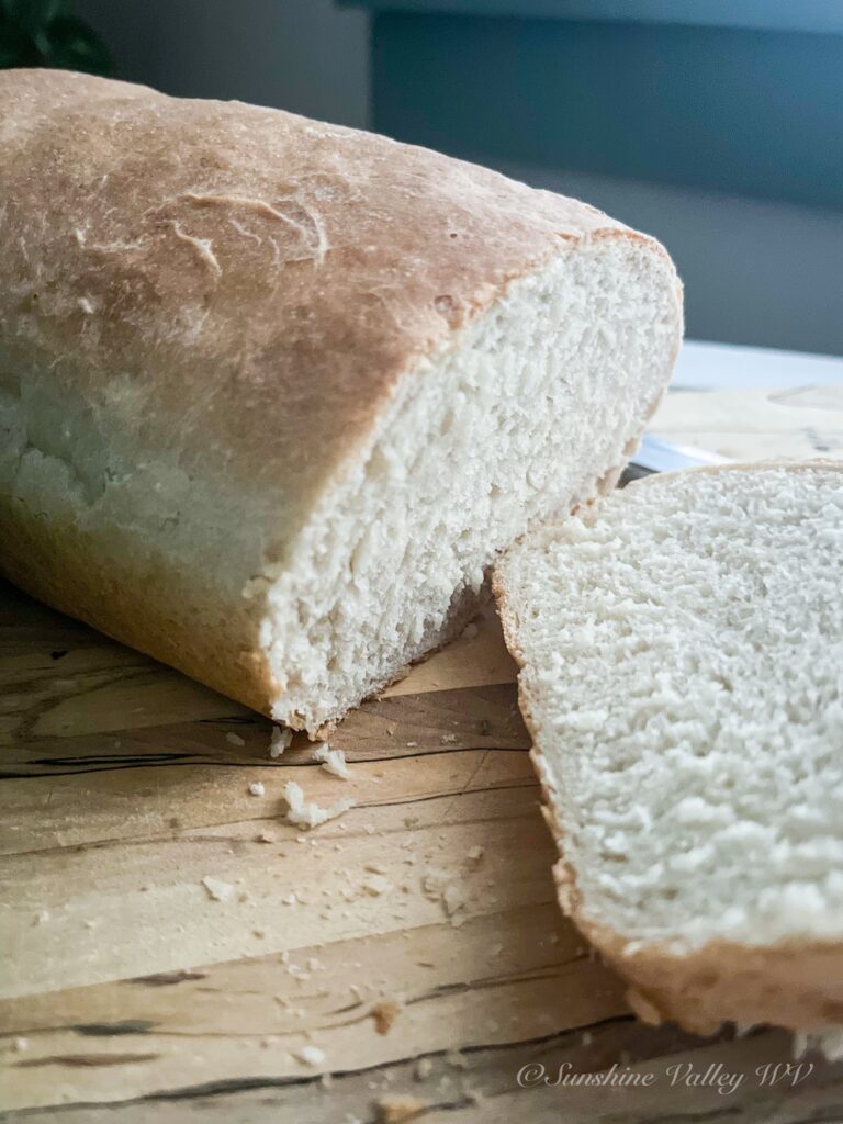 How to Make Simple 4-Ingredient Bread Recipe (No Fuss, No Starter) 4 simple 4-ingredient bread fresh from the oven on a wooden cutting board.