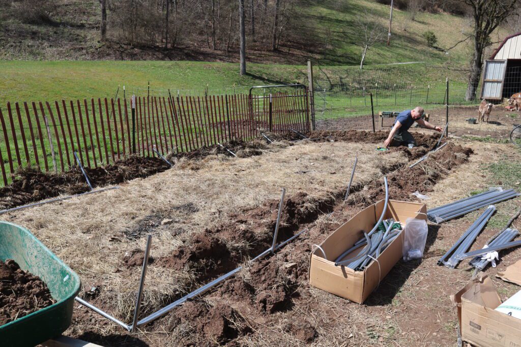 What To Know Before Building a Hoop House 2 trench dug for hoop house base for stability